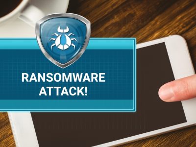 29721714_ransomware-attack-box-and-hand-touching-phone